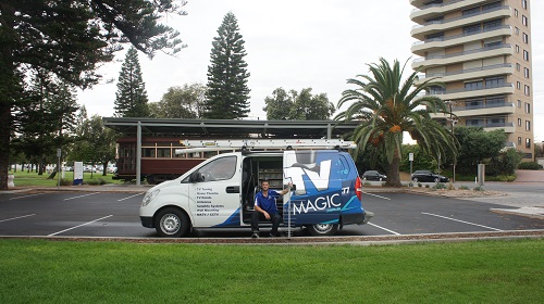 technician with his TV Magic van, holding an aerial