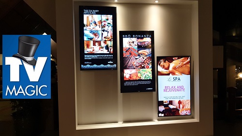 multi TV display in front of house in a retail outlet. TV Magic logo in blue and white on left hand side