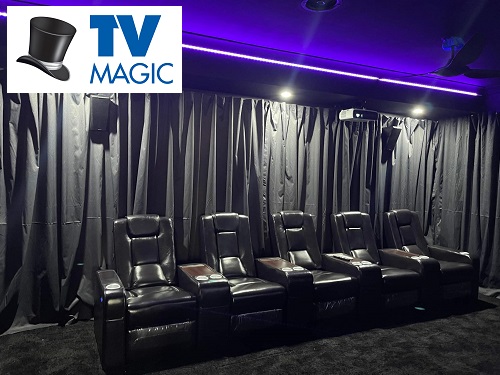 cinema style leather recliners in front of black curtains in the back of a home cinema. TV Magic logo in top left corner