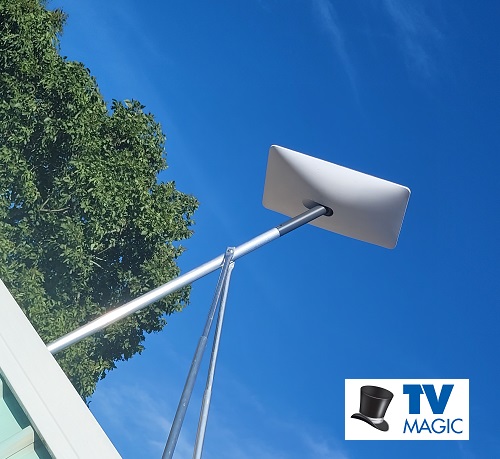 Starlink installation on a tin roof with a TV Magic Logo in bottom right corner