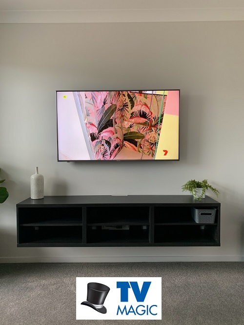 a freshly wall mounted TV fully setup by TV Magic. TV Magic logo in bottom centre of picture