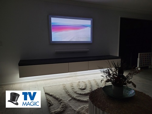 a wall mounted Samsung Frame TV with a floating sound bar. TV Magic logo in bottom left corner
