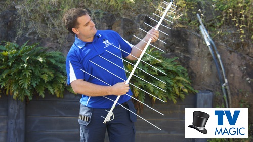 Technician holding an antenna. Logo in bottom right corner