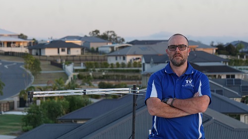 Technician standing with an aerial he installed
