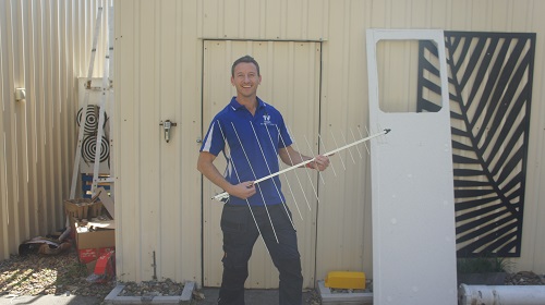 Technician holding an antenna