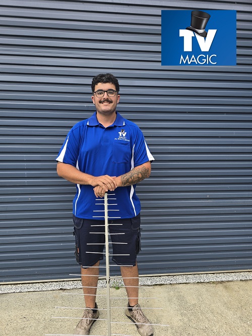 Technician Kyle holding an antenna