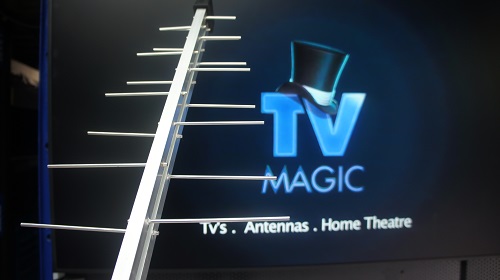 Large TV screen with an antenna in front of it.