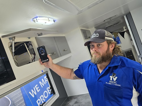 Technician - Nick, in a customers caravan, showing Starlink speed