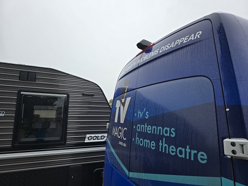 Caravan and TV Magic van side by side