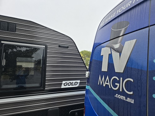 TV Magic van next to customers caravan