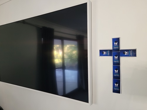 Large screen with a cross made from TV Magic stickers