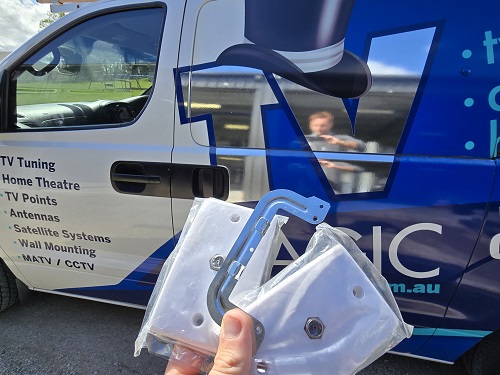 Technician holding TV Points up in front of van