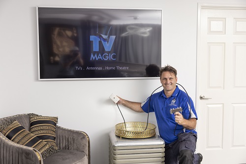 Technician holding a TV point ready for installation