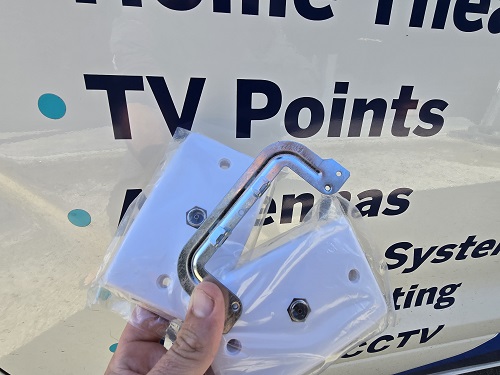 Technician holding up TV points in front of his van