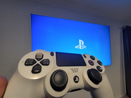 Gaming controller in front of large screen
