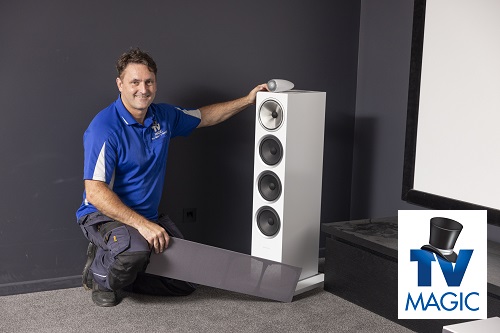 Technician in a home cinema he designed. 