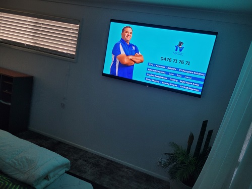 Wall mounted TV with technician - Darrel on screen with his service menu