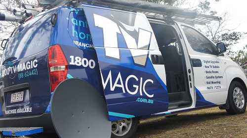 TV Magic van with satellite dish leaning against it