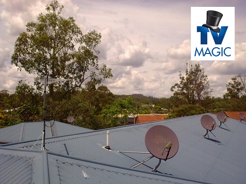 Multiple satellite dishes on the roofs of homes. TV Magic logo in top right corner