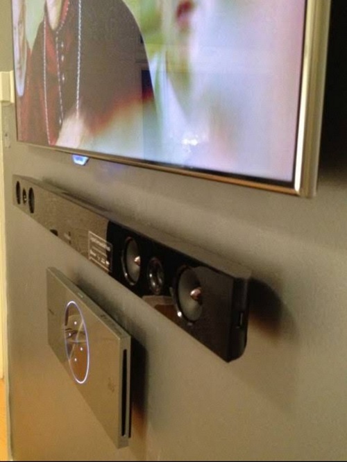 close up of a wall mounted TV with floating sound bar installation