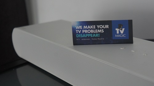 close up of a sound bar with TV Magic biz card on top