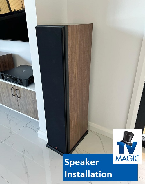 close up of a tall free-standing speaker. Caption "Speaker Installation" and TV Magic logo in bottom right corner