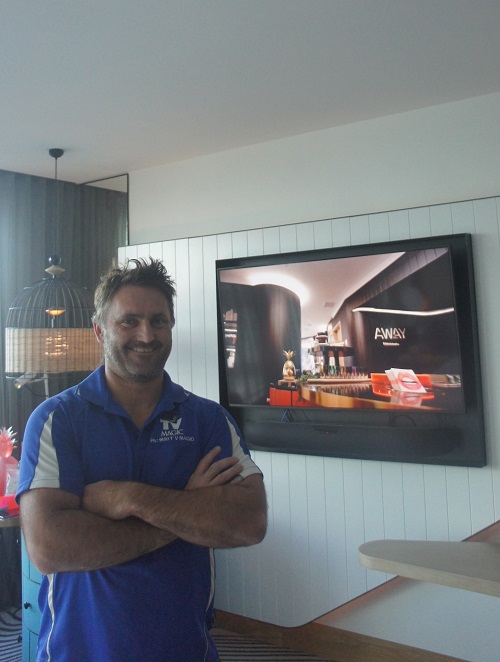 technician in front of TV installation