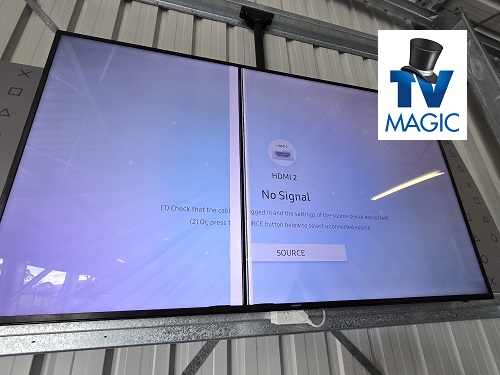 Large TV screen with lines on screen with obvious damage. TV Magic logo in top right corner