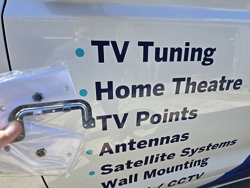 A TV Point being held in front of TV Magic signage