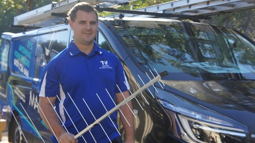 Technician - Nathaniel, holding an antenna
