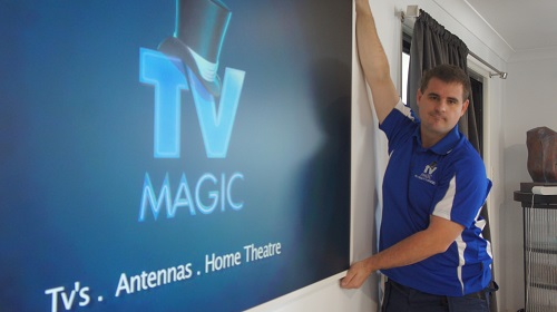 Technician finishing off a wall mounting service. Logo on screen