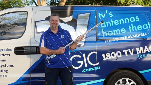 Technician - Anton, holding an antenna next to his van
