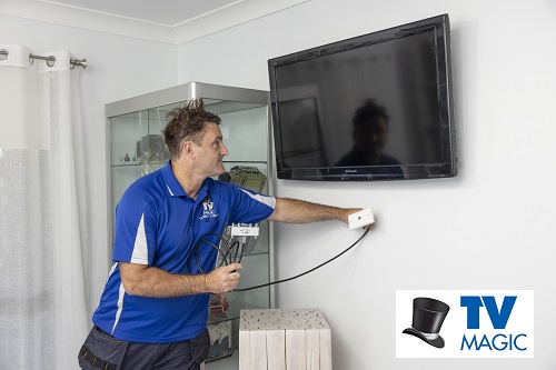 Technician holding a TV point, placing for installation