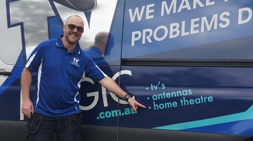 Technician pointing at services on the side of his van