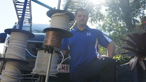 Technician with various cables for pre-wire fit outs