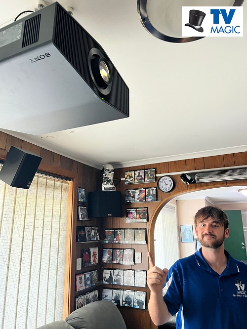 Technician with a projector he replaced the lamp in