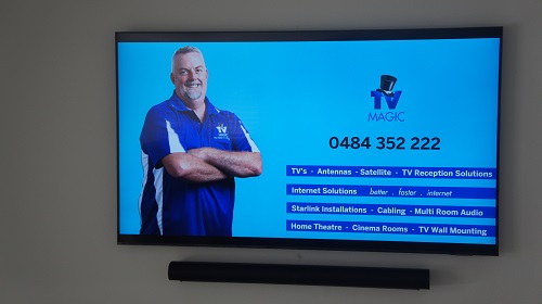 Wall Mounted TV with soundbar by TV Magic. Technician - Anton on screen with his services available.