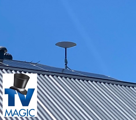 A TV Magic Starlink installation on a tin roof. TV Magic logo in bottom left corner