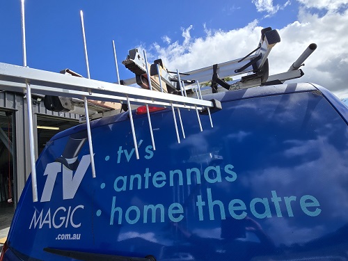 An antenna in front of a TV Magic van