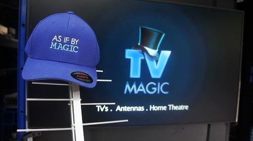 An antenna in front of a TV with TV Magic logo on screen. TV Magic cap on top of antenna