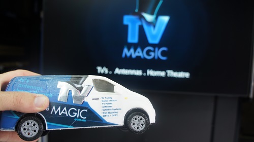 Mini TV Magic van being held up to a large screen