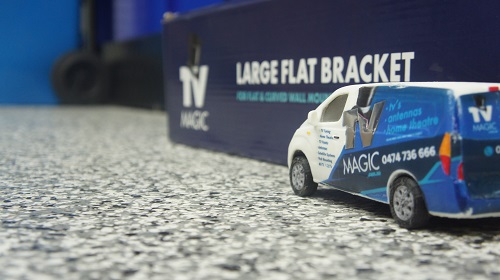 Mini TV Magic van next to a TV Magic wall mounting bracket