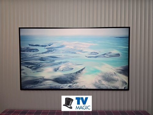A TV Magic wall mounted TV. Logo in bottom middle
