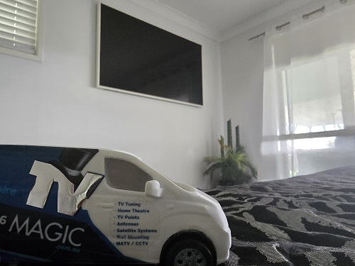 Wall mounted TV with a mini TV Magic van down below