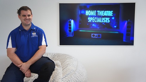 Techncian next to a freshly wall mounted TV