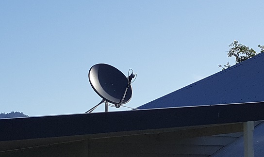 satellite dish installed on a tin roof