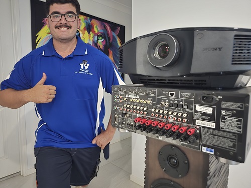 Technician standing next to projector equipment