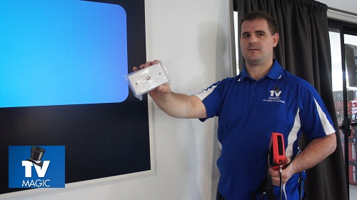 Technician holding up a TV point in front of a large screen. Logo in bottom left corner.