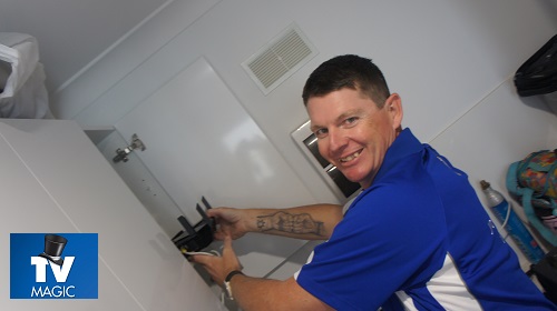 Technician holding a modem post installation.