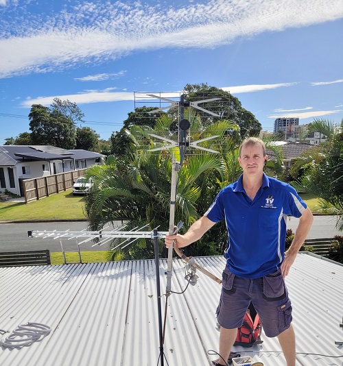 Technician with an aerial he installed